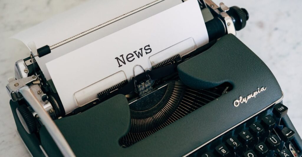 Close-up of an antique typewriter with 'News' on paper.